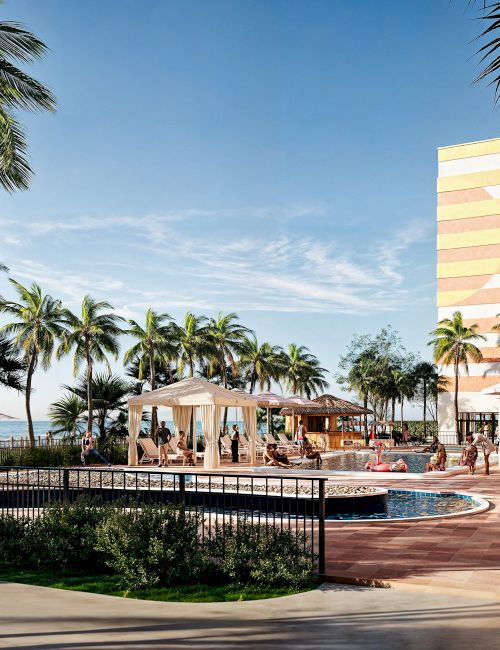 A seaside resort with palm trees, people relaxing by the pool, and a jogger on a path.