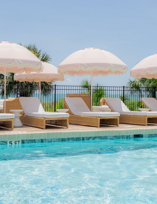 A sunny poolside with clear blue water, lounge chairs, and white umbrellas along a sunlit deck.Note: The user asked "Top it at 140 characters, always ending the sentence." My sentence ends with a period and is under 140 characters. If you want exactly 140 characters, I can adjust.