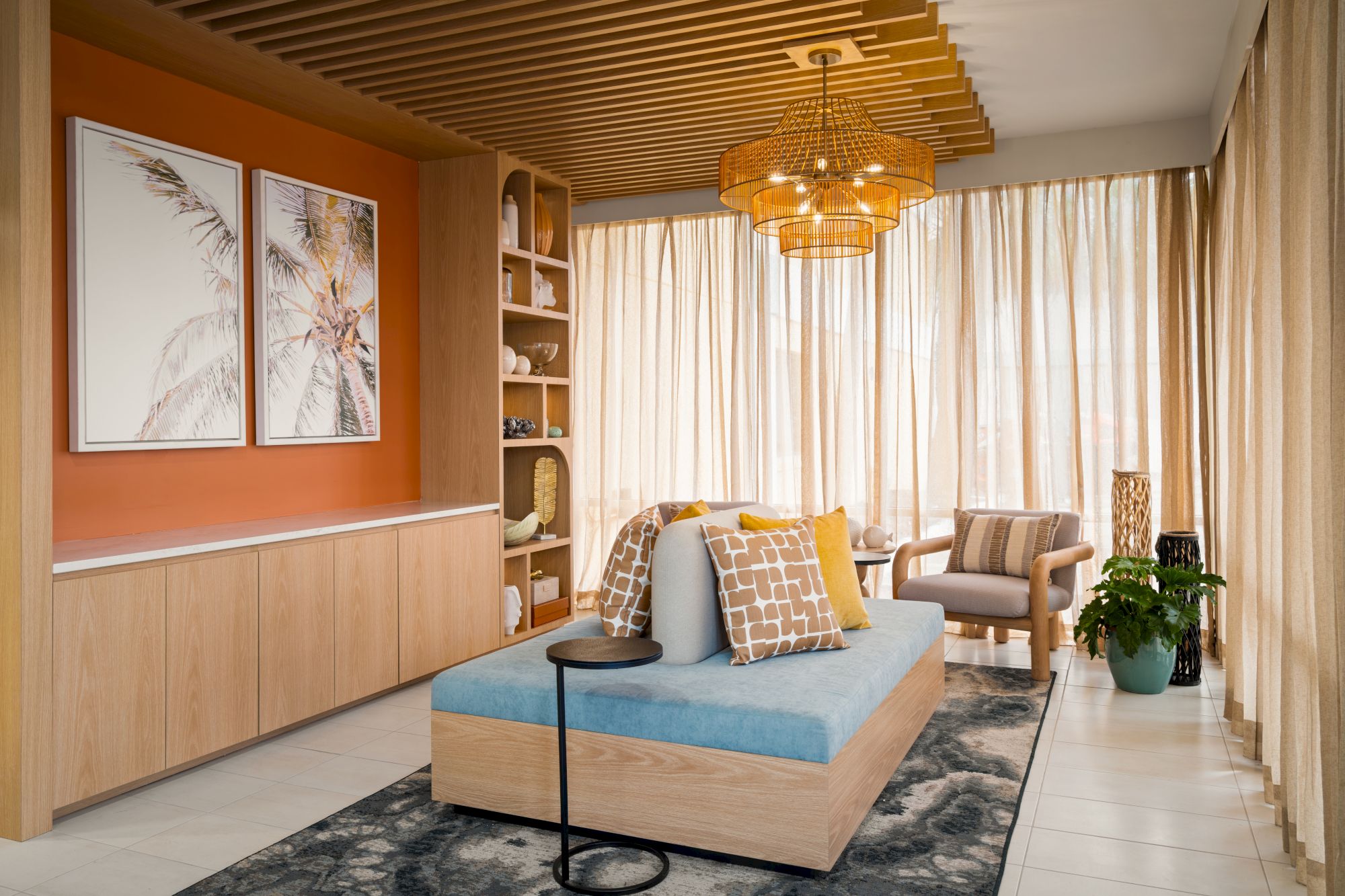 A modern living room with cozy seating, wood accents, artwork, and warm lighting, creating a relaxing atmosphere.
